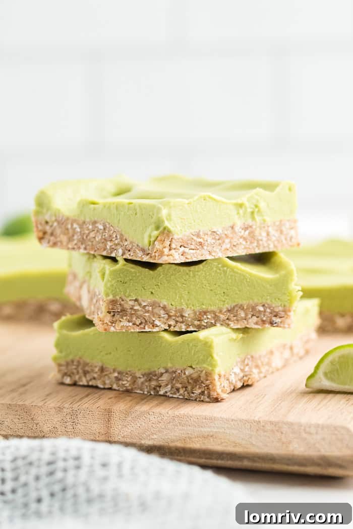 Artfully arranged Skinny Vegan Key Lime Pie Bars on a rustic wooden board, ready to be served, highlighting their fresh and inviting appearance.