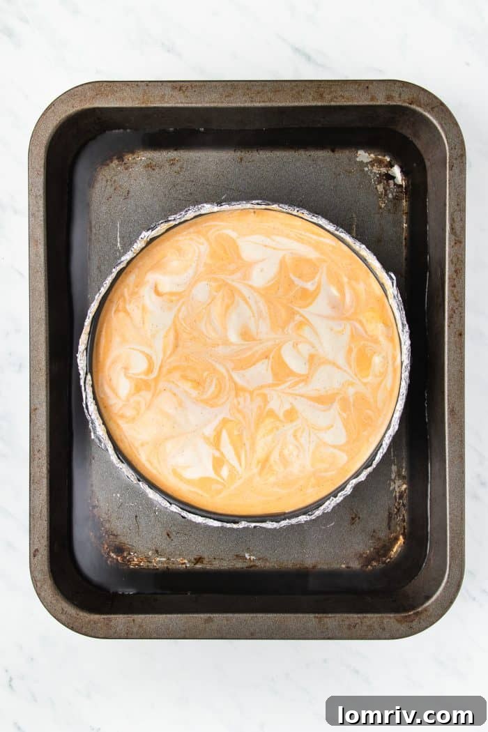 The unbaked cheesecake in a baking pan.