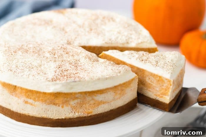 A closeup of a cheesecake with a slice being removed.