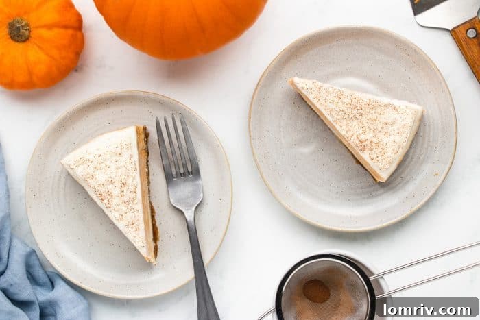Two slices of pumpkin cheesecake on white plates.