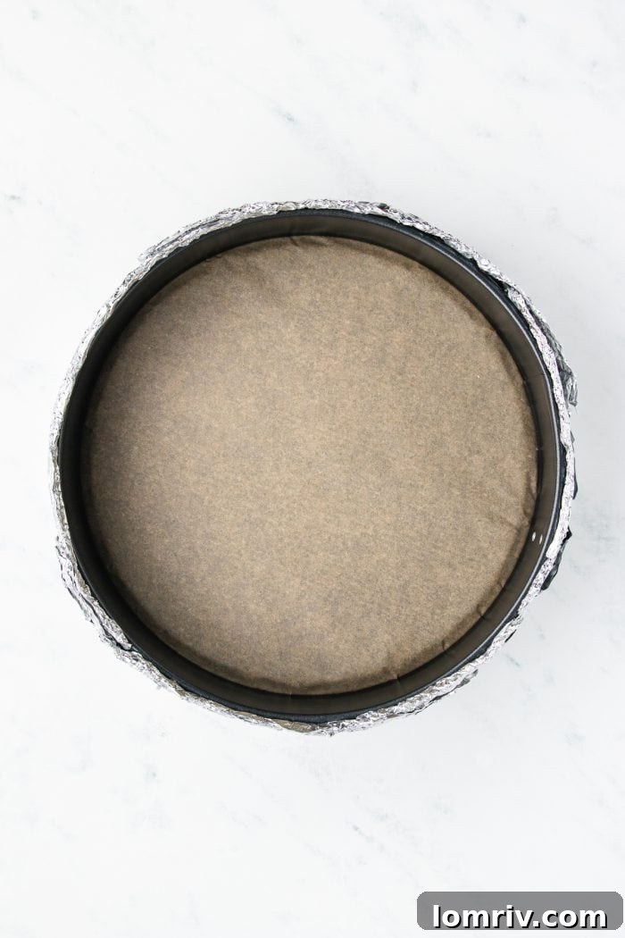 A cheesecake pan that has been wrapped in tin foil.