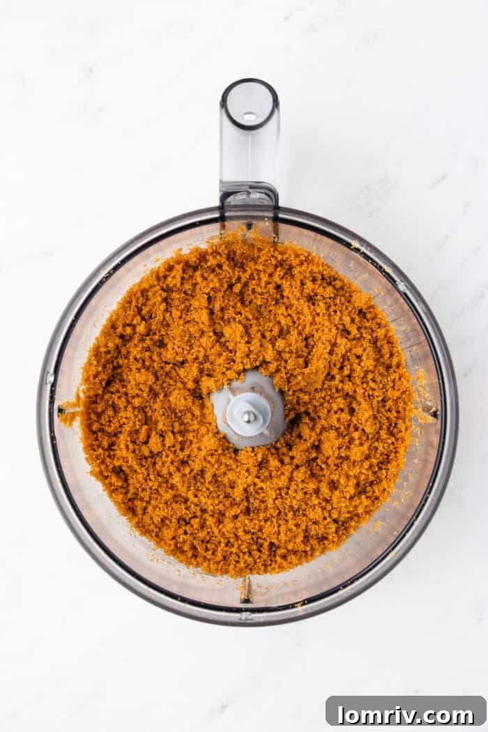 Gingersnaps crumbs in a food processor with butter added.