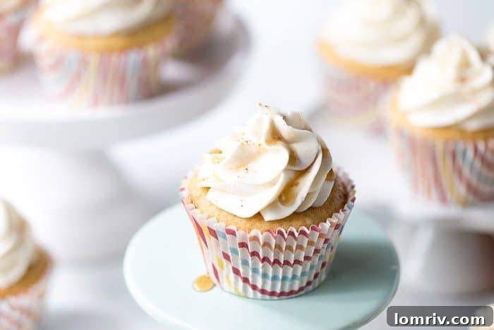 Close up of a frosted cinnamon maple cupcake on a serving tray