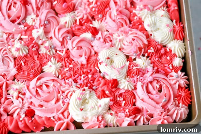 A close-up of the finished Valentine's Day sheet cake, showcasing the intricate buttercream details and vibrant colors.