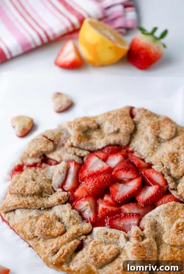 Baked rustic strawberry galette, golden brown with juicy fruit, ready to serve