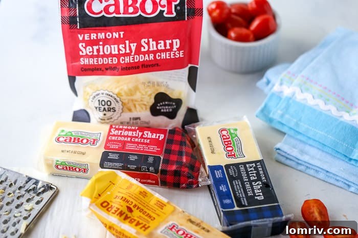 A variety of Cabot cheese products, including blocks of cheddar and shredded cheese, displayed on a rustic wooden surface