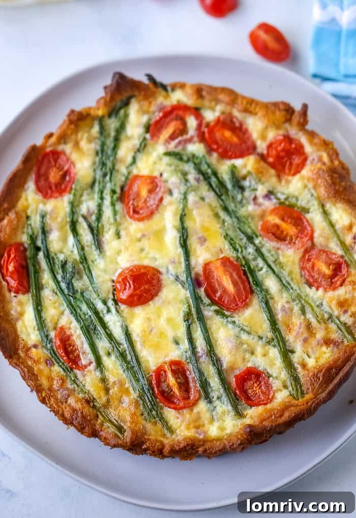 The final beautifully presented Easy Asparagus Cheese Tart, showcasing its golden crust and colorful topping, ready to be sliced and served