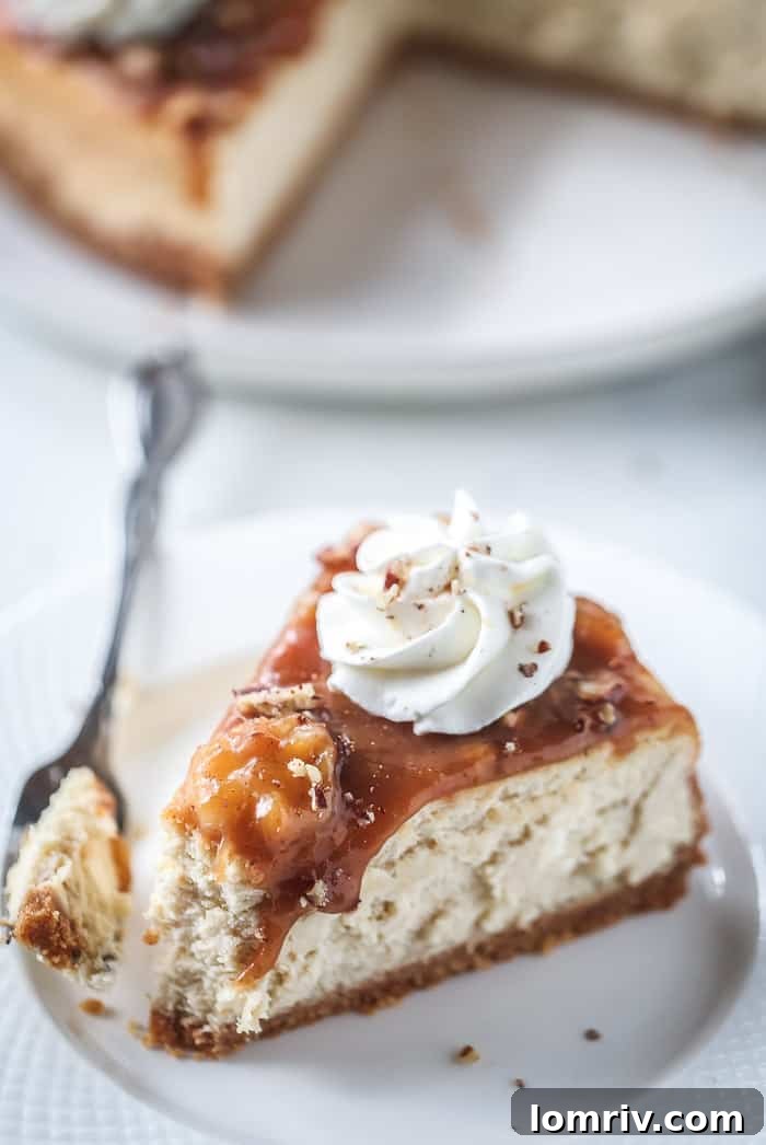 A close-up of a slice of Banana Foster Cheesecake, highlighting the layers of crust, filling, and topping.
