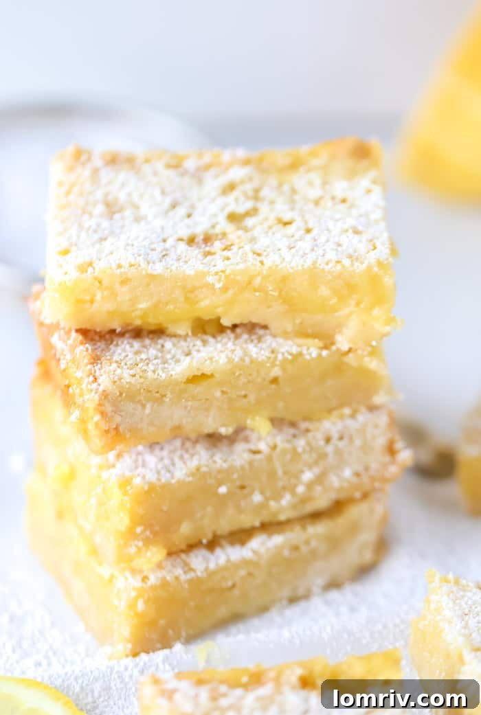 Classic Lemon Bars with Tangy Lemon Curd Filling dusted with powdered sugar