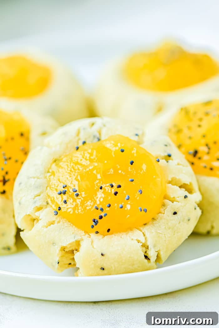 A plate brimming with freshly baked Lemon Poppy Seed Thumbprint Cookies, ready to be enjoyed