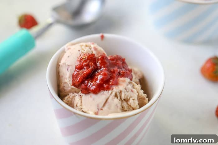 A bowl of freshly churned homemade strawberry ice cream, ready to be frozen or served immediately.