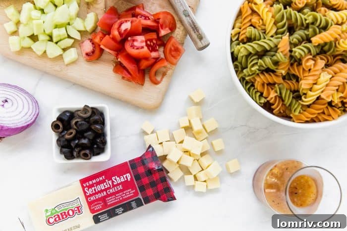 Various fresh ingredients laid out on a wooden board, ready for a homemade summer pasta salad