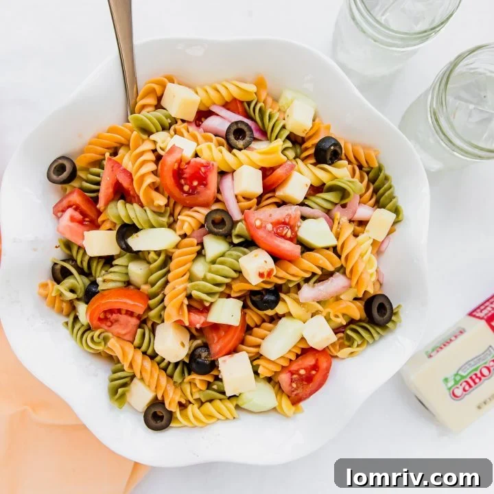 Summer Pasta Salad with fresh vegetables and sharp cheddar, beautifully presented in a bowl