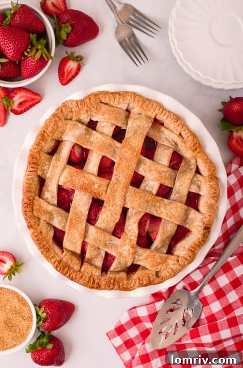 A perfectly baked homemade strawberry pie, golden and bubbly, fresh out of the oven.