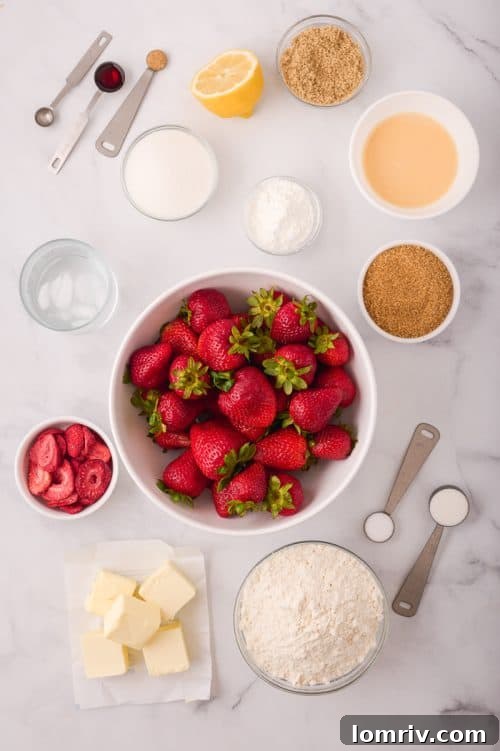 An array of fresh strawberry pie ingredients laid out in bowls, including fresh strawberries, flour, sugar, and extracts.