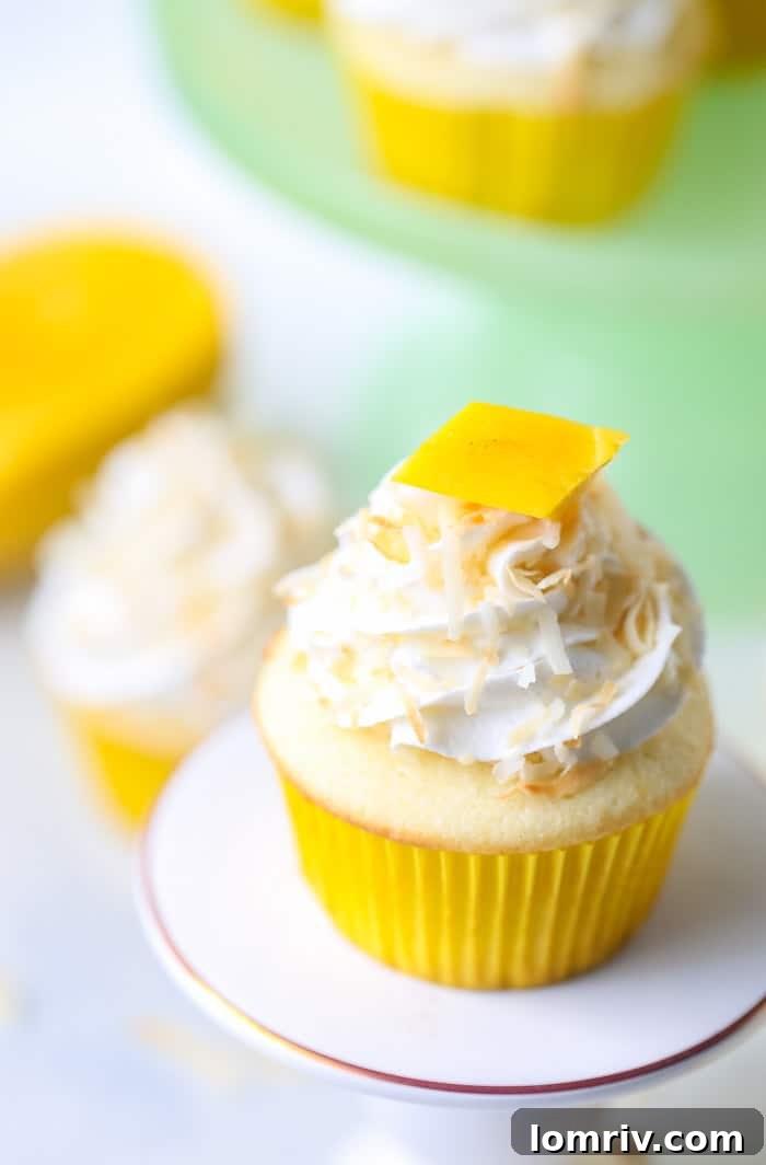 Close-up of Mango Coconut Cupcakes with Fresh Mango Slices