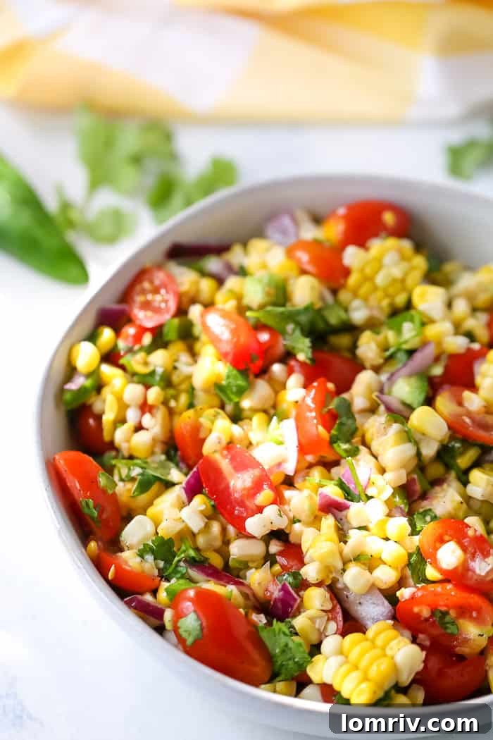 Close-up of a refreshing Summer Corn Salad with lime wedges