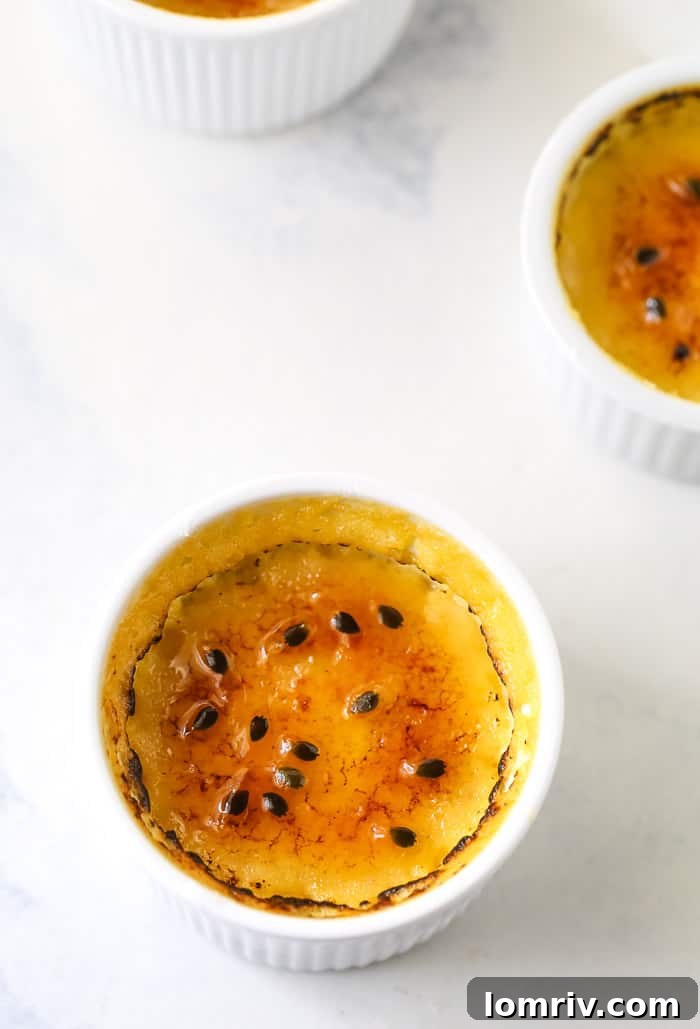 Single ramekin of Passionfruit Creme Brulee garnished with fresh passionfruit pulp