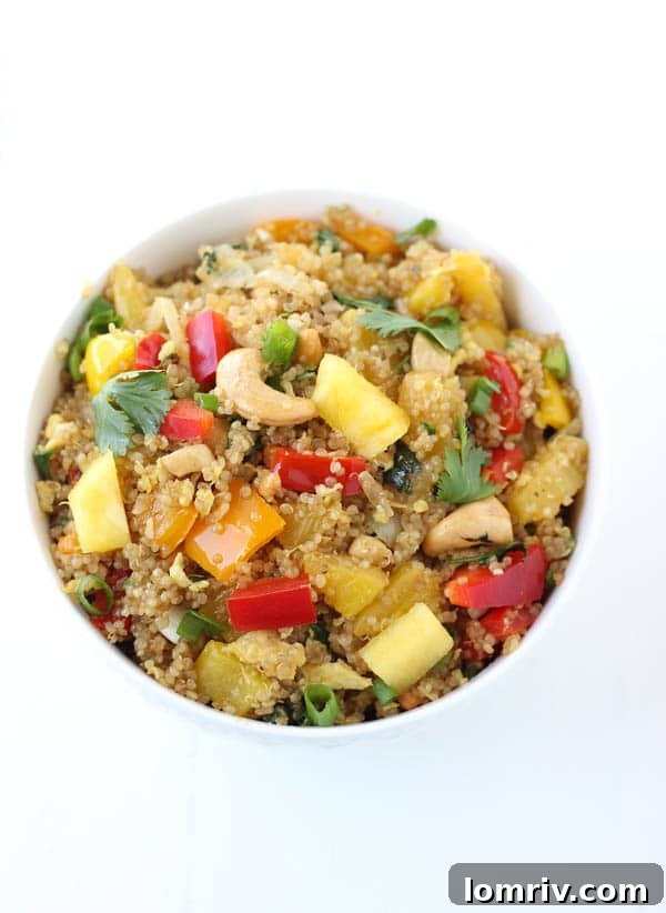 A bowl of vibrant Pineapple Cashew Quinoa Fried Rice