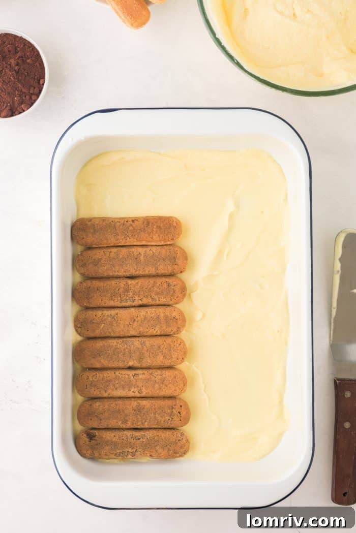 Dipping ladyfingers in coffee for Tiramisu