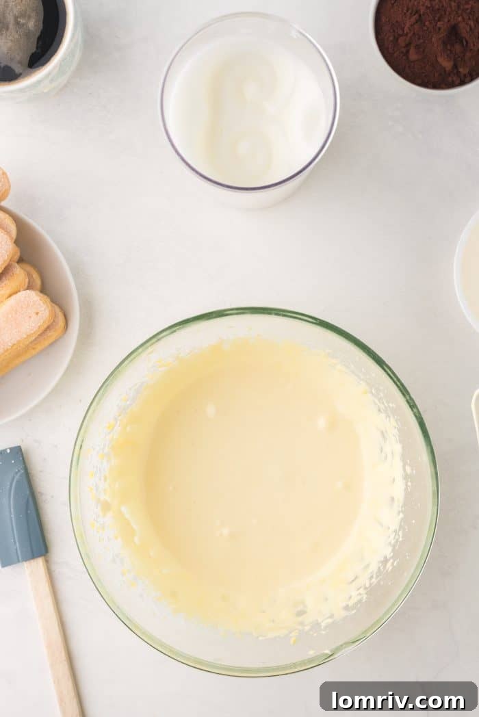 Whisking egg yolks and powdered sugar until light and fluffy