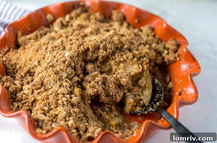 Overhead shot of the pear crisp, showcasing the uniform distribution of the oat crumb topping.