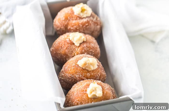 Close-up of a Caramelized Pears and Mascarpone Donut with fresh pears in the background