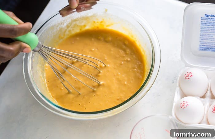 Closer view of wet ingredients being mixed for sweet potato scones