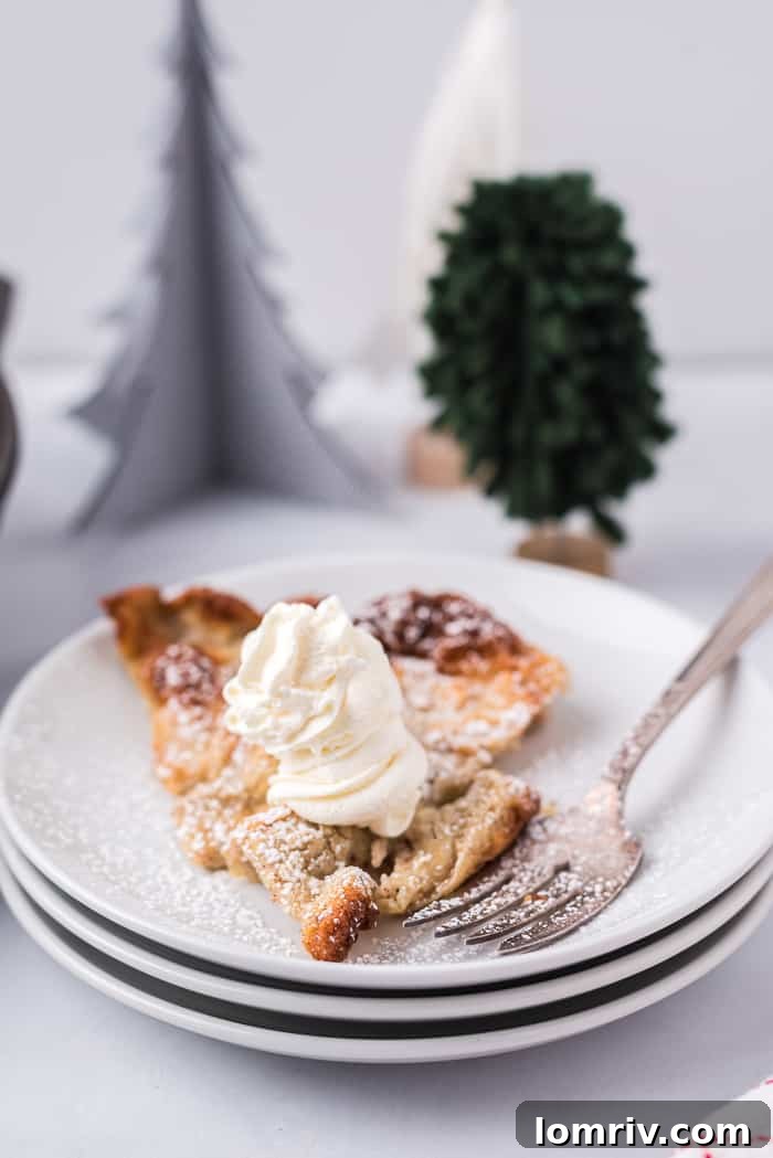 A Gingerbread Dutch Baby Pancake served on a white plate, ready to be eaten