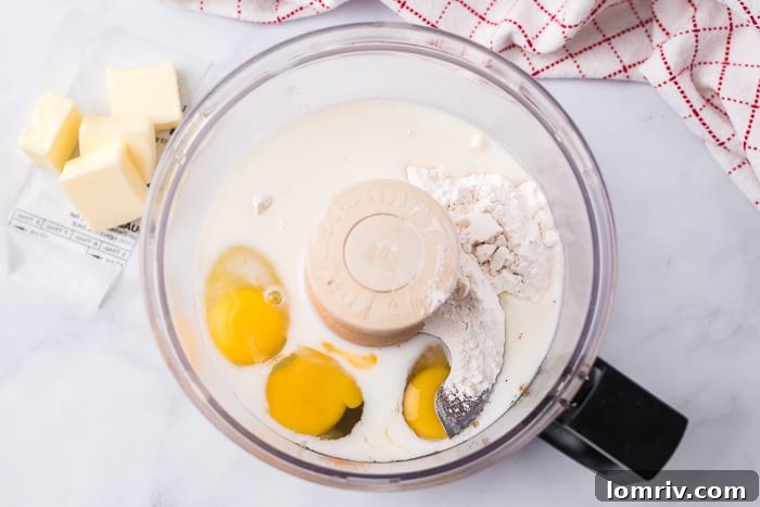 Gingerbread Dutch Baby Pancake batter resting in a food processor
