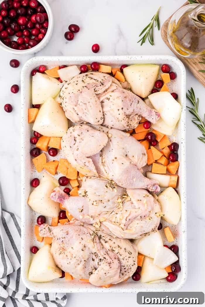 Tossing chicken with oil and herbs for sheet pan meal.