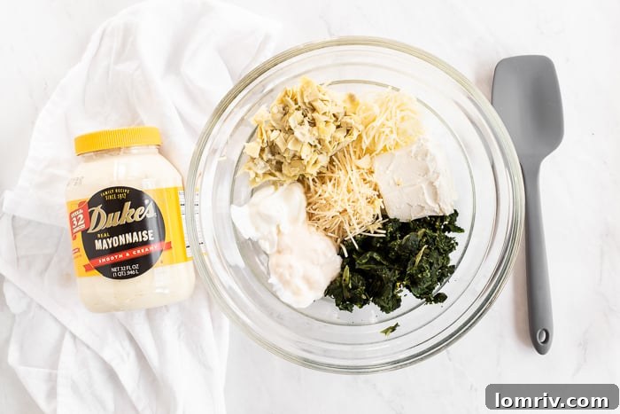 Mixing the spinach artichoke dip ingredients