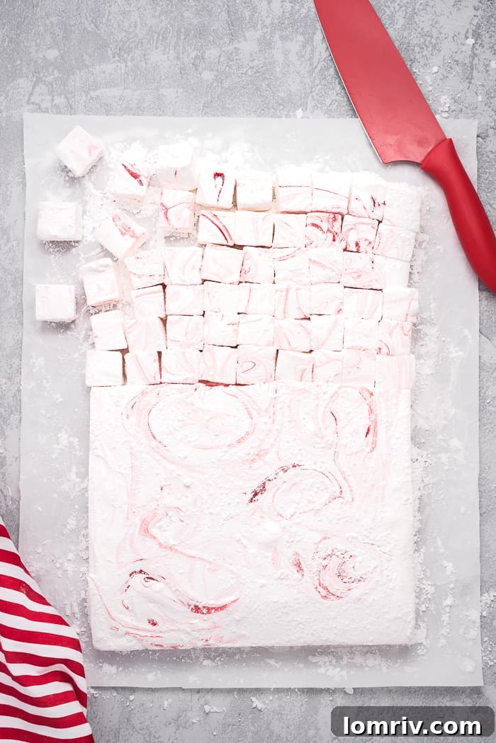 Pouring homemade peppermint marshmallow mixture into a pan