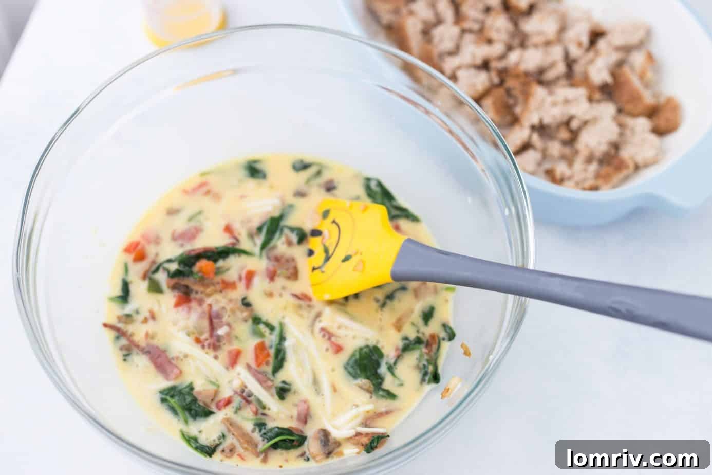 Prep ingredients for breakfast casserole including cooked meats and sautéed vegetables