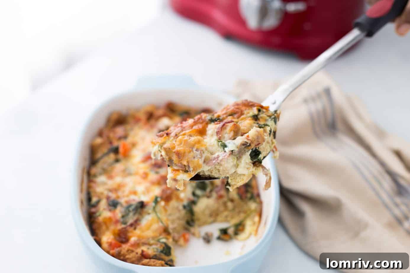 Breakfast Casserole slice on a plate with coffee and toast, ready to be enjoyed