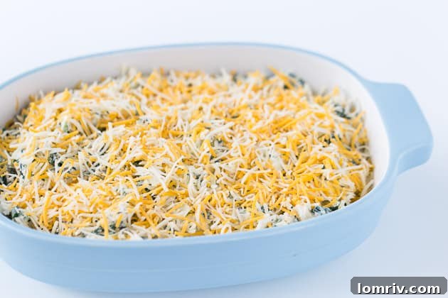 Close-up of bubbling hot Spinach Artichoke Dip in a baking dish