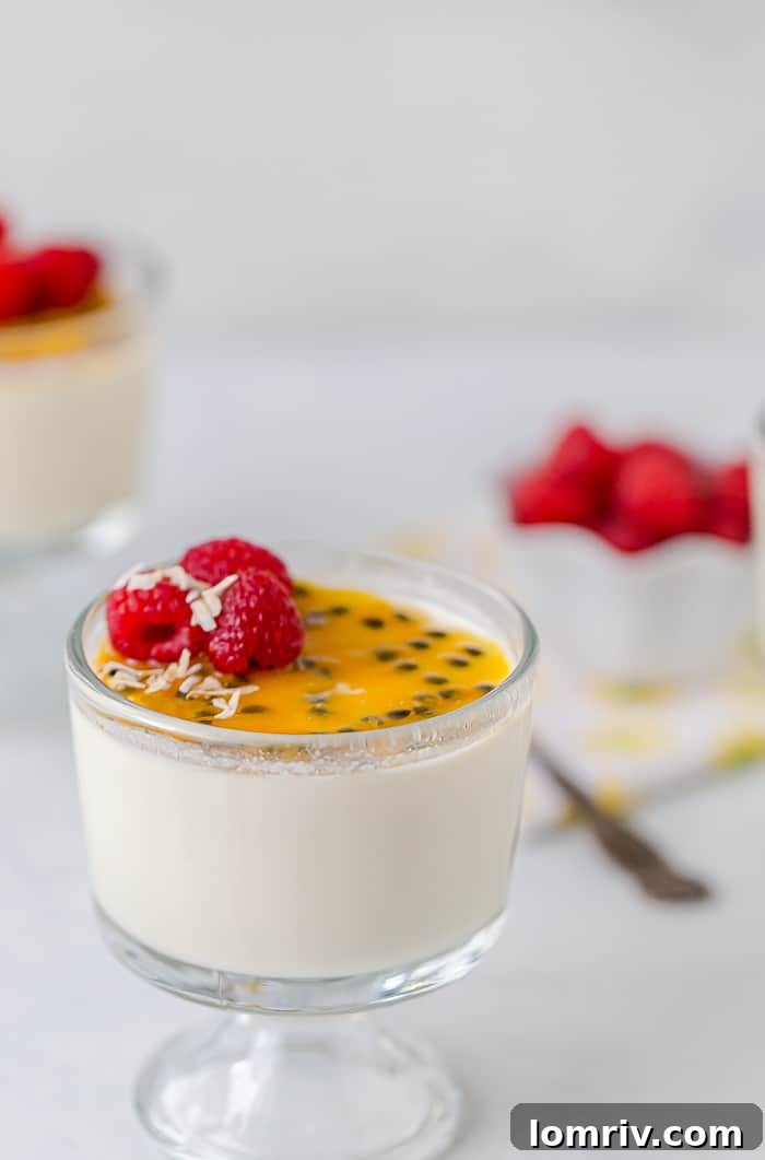 Passionfruit Coconut Panna Cotta with fresh berries and coconut flakes.