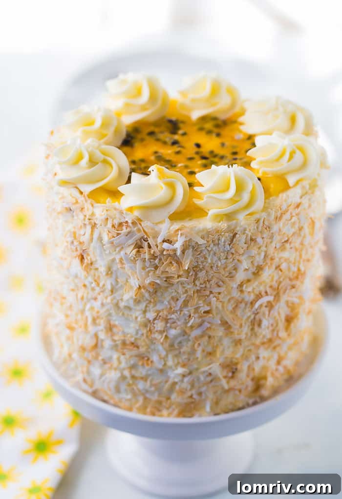 Close-up of a slice of Passionfruit Coconut Layer Cake showing layers.