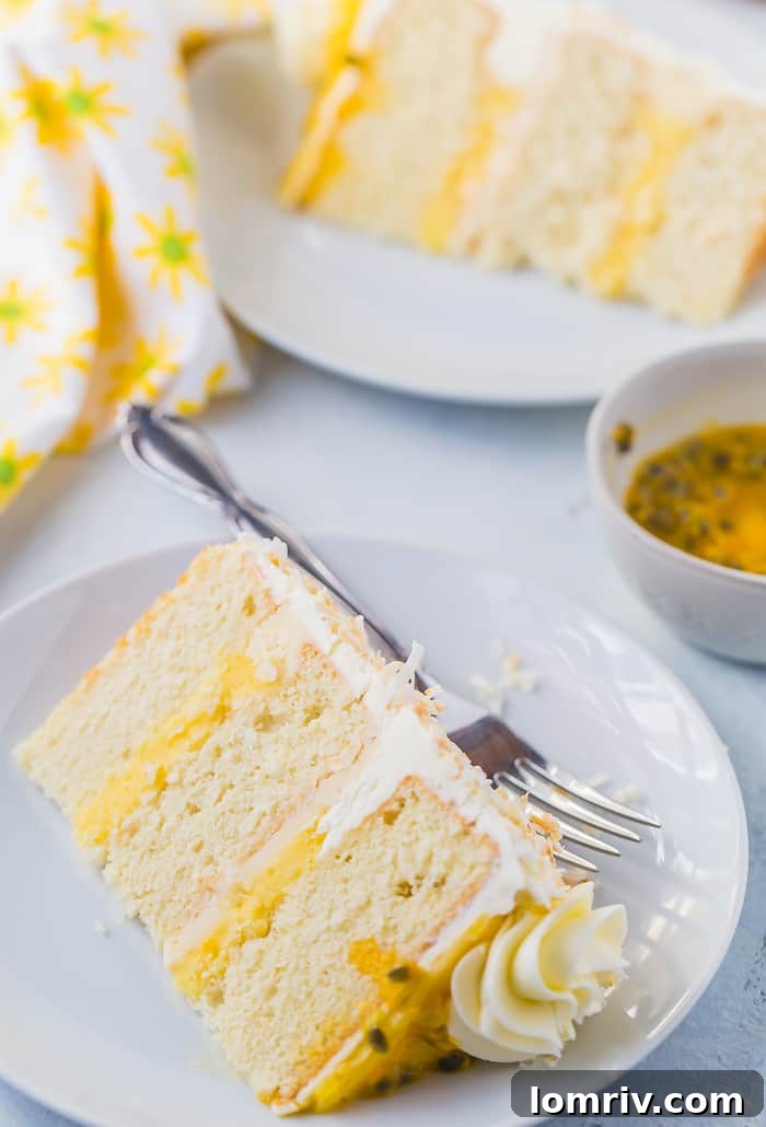 A stunning side view of Passionfruit Coconut Layer Cake ready to serve.