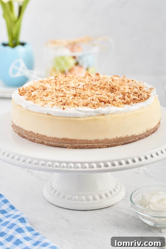 Lush Coconut Cheesecake on an elegant cake platter, ready to be served for a special occasion.