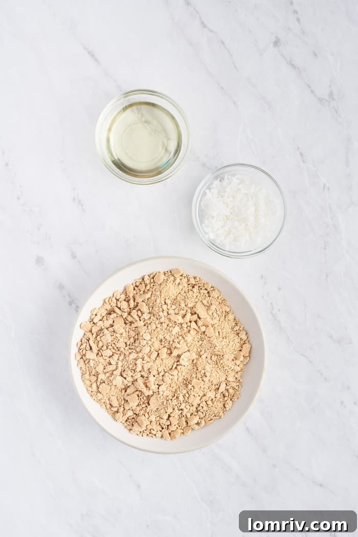 Individual ingredients for Coconut Cheesecake crust: graham cracker crumbs, unsweetened coconut flakes, and coconut oil.