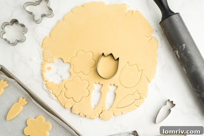 Assortment of spring-themed cookie cutters, including carrots and various flowers