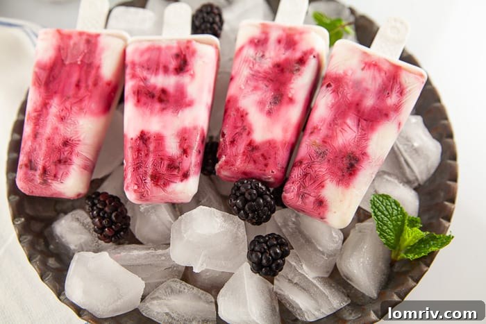 Blackberry Popsicles cooling on a plate, ready to be enjoyed.