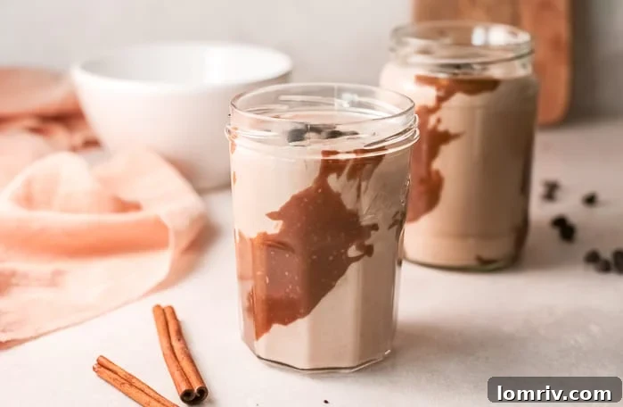 Close-up of a Banana Bread Smoothie in a glass, with oats on top