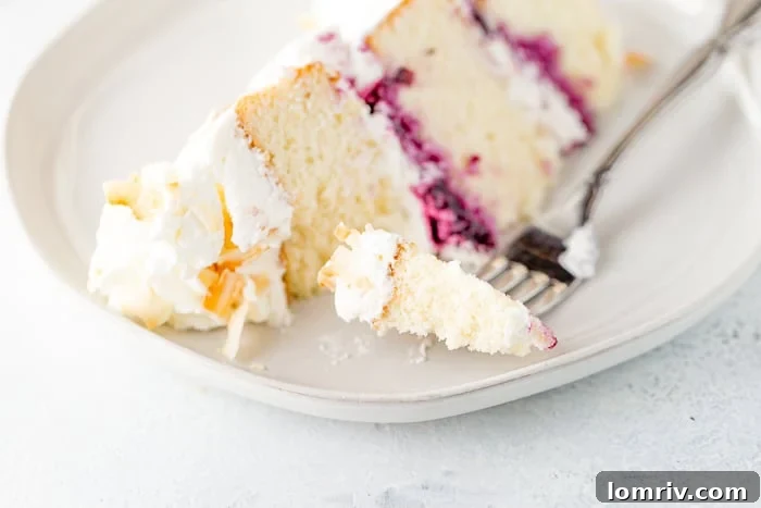 Coconut Blueberry Layer Cake with a rustic, 'naked' frosting style.