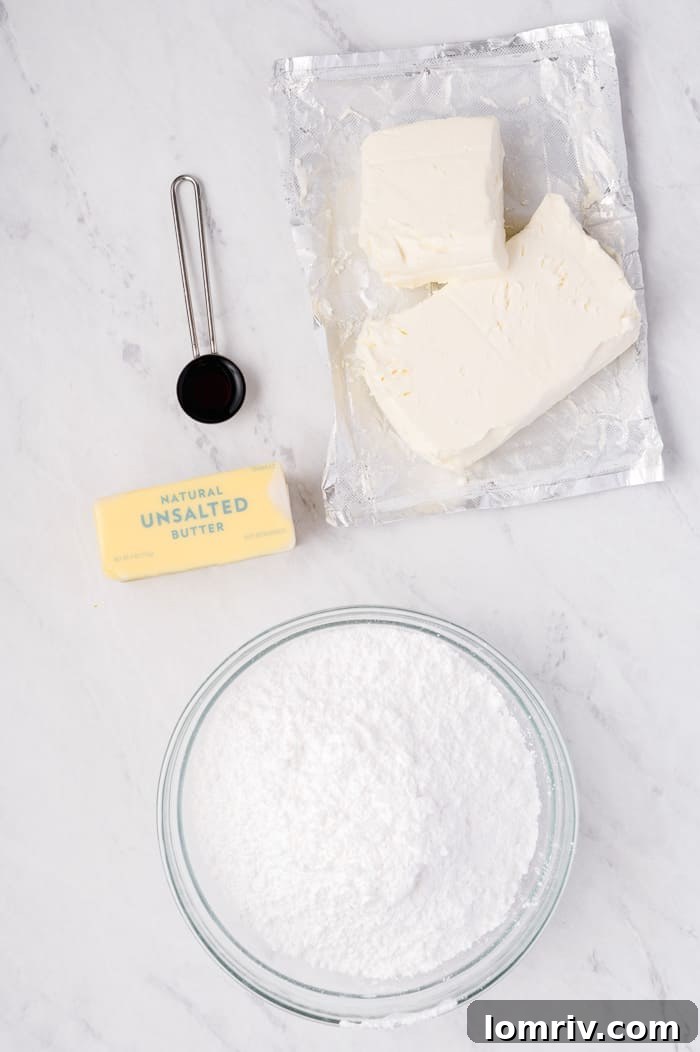 Powdered sugar being added to the creamed butter and cream cheese for the frosting.