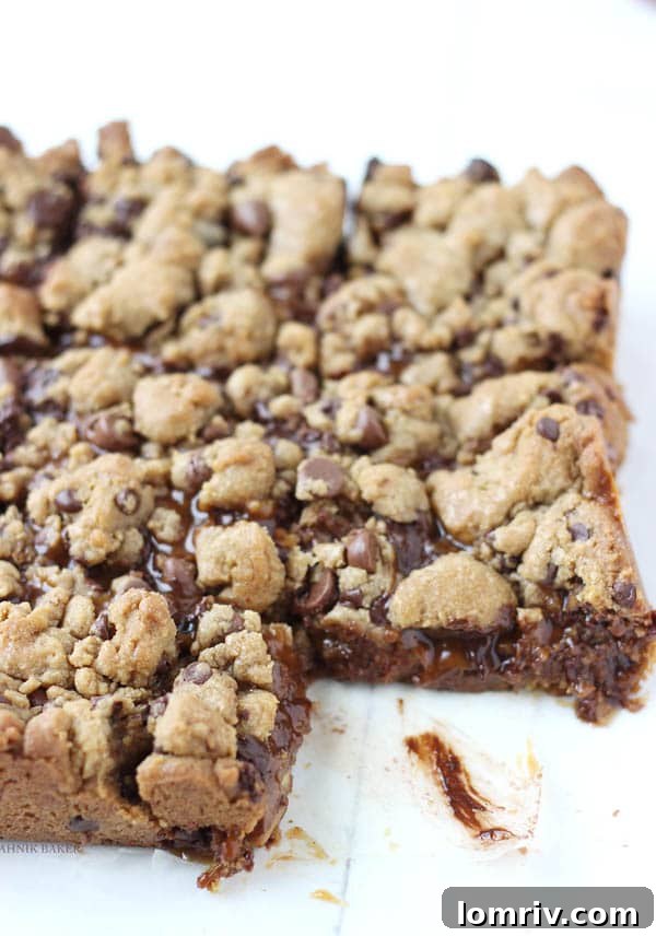 Delicious Salted Caramel Twix Cookie Bars on a baking sheet, perfect for a cozy movie night