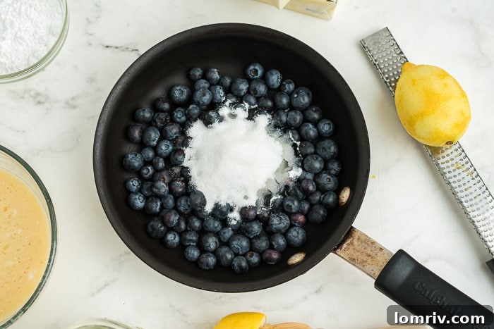 Preparing the blueberry compote for Coconut Blueberry Cupcakes in a saucepan.