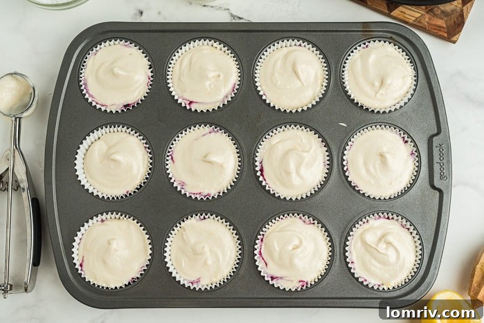 Baked Coconut Blueberry Cupcakes cooling on a wire rack.