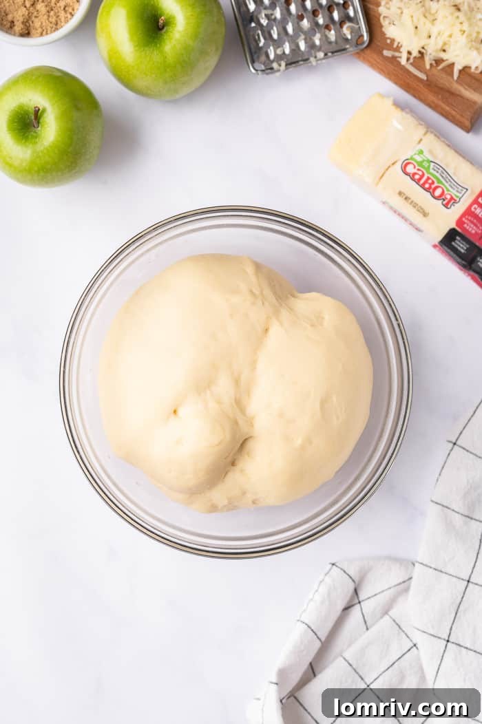 Dough with grated Cabot Sharp Cheddar Cheese undergoing its first rise
